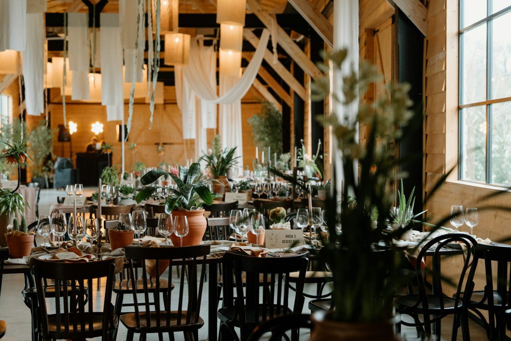 Real wedding reception tables with flowers, candles and table settings